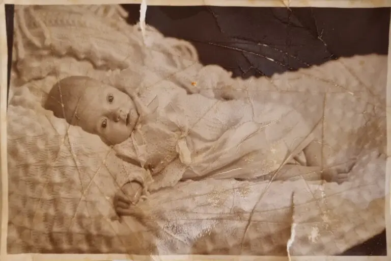 baby lying on a sofa in black and white