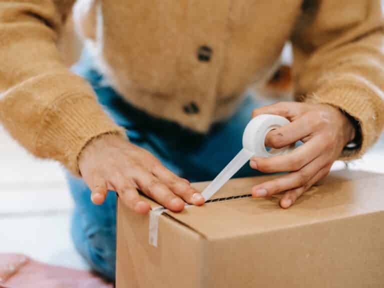 Supaphoto employee packing customer film in box.