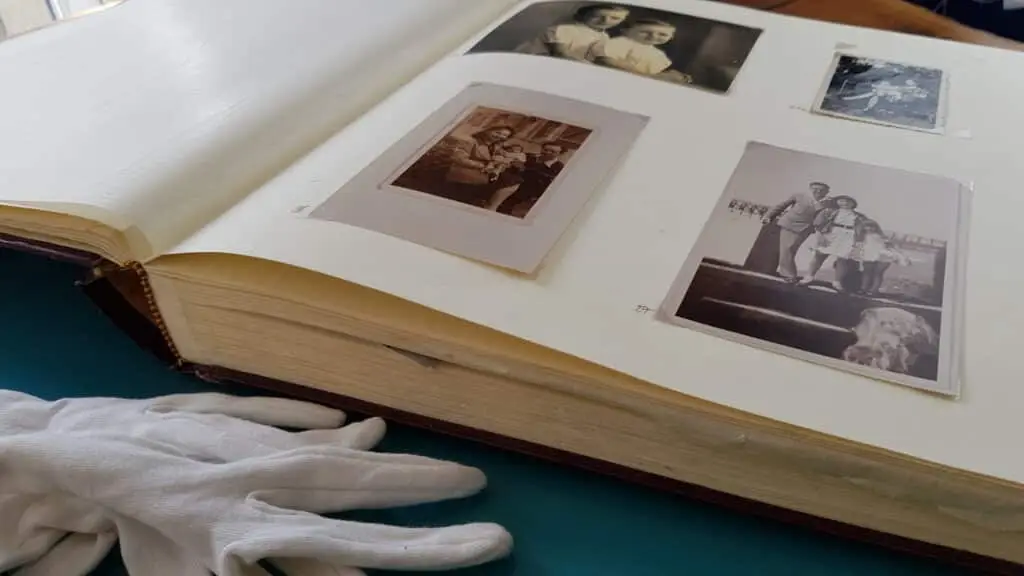 photo album with old photos with protective sleeve covering them, preserve old photographs