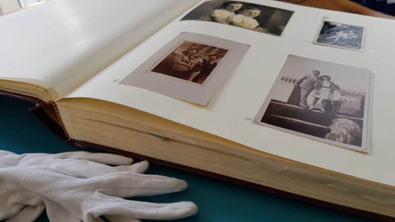 photo album with old photos with protective sleeve covering them