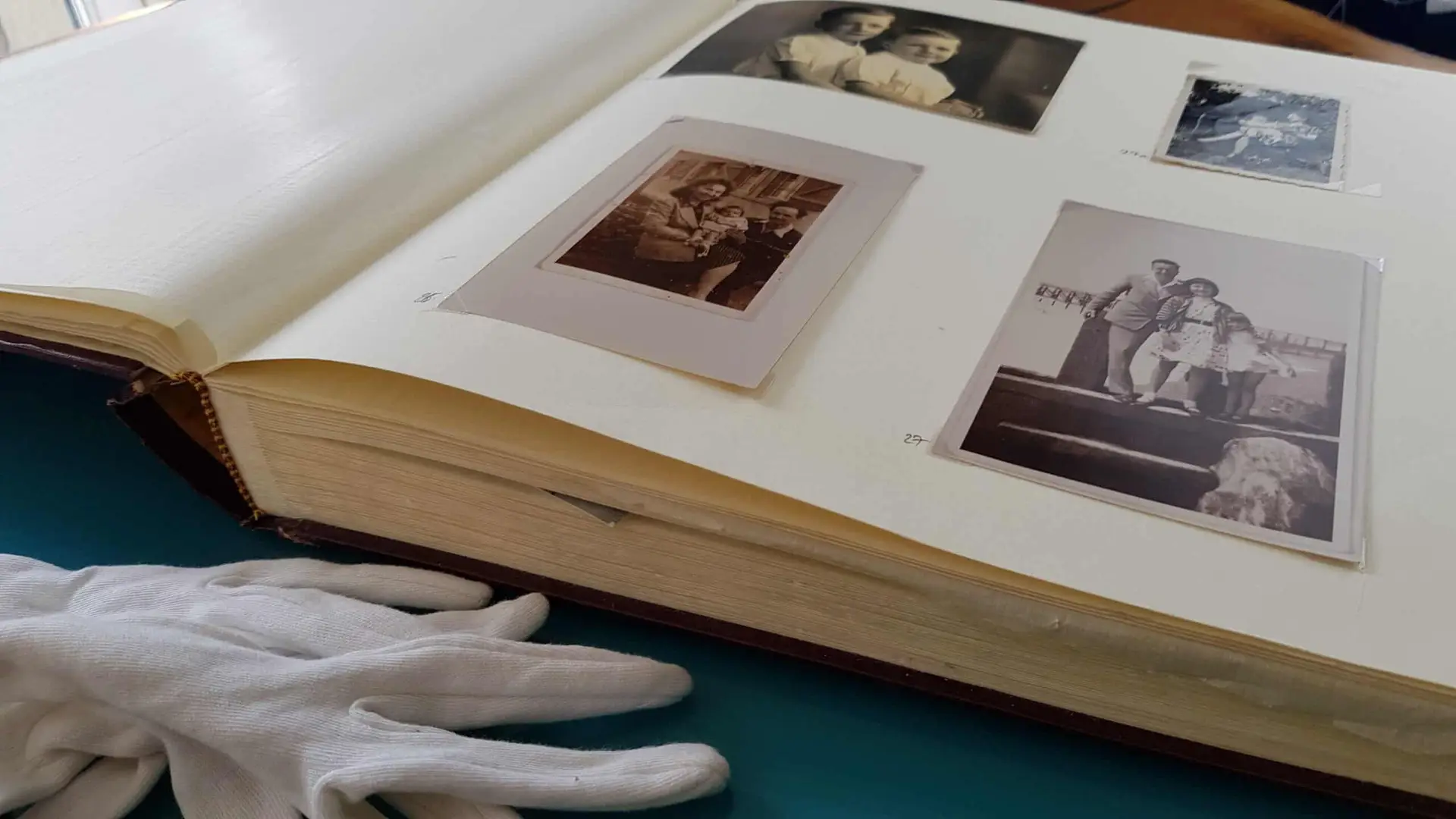 photo album with old photos with protective sleeve covering them, preserve old photographs