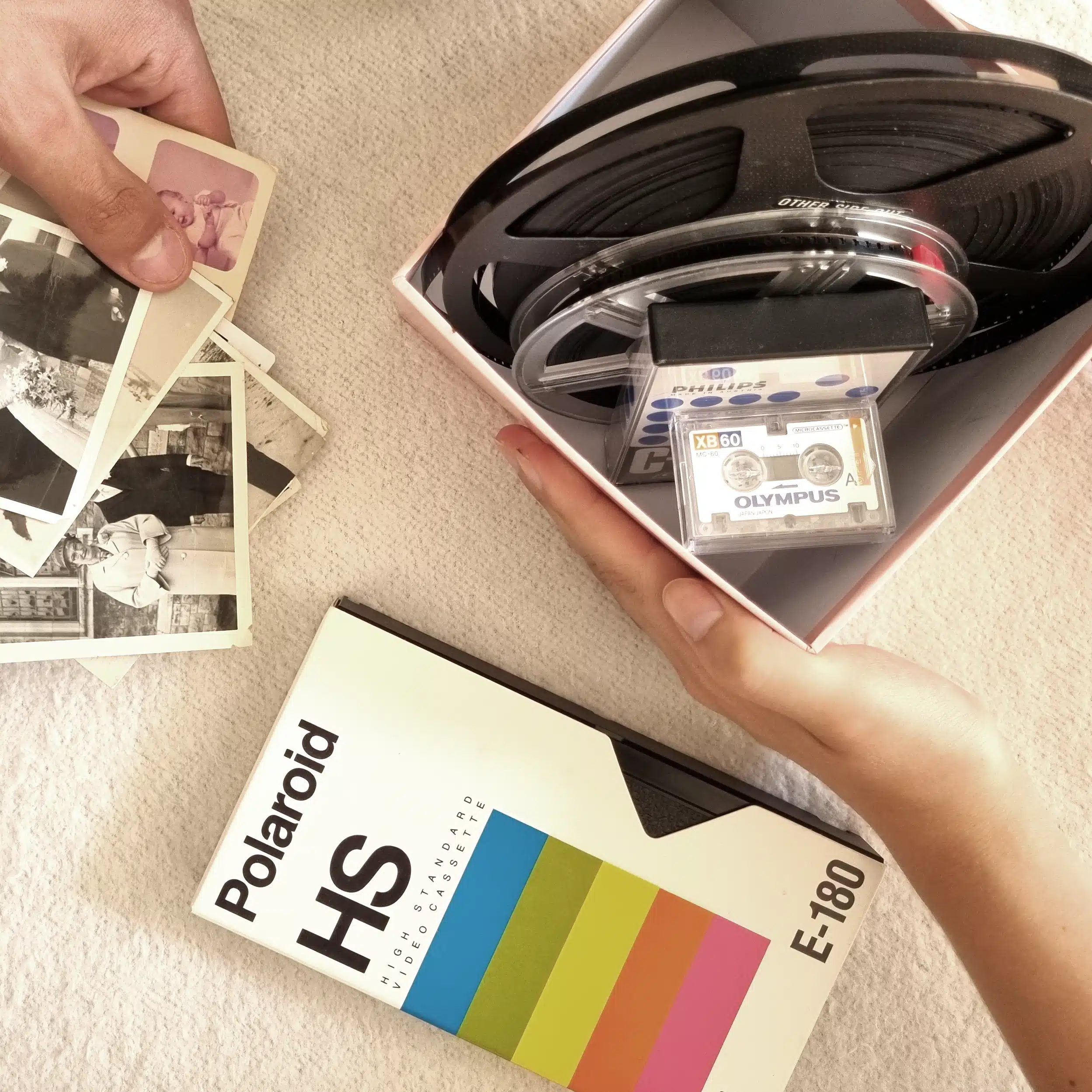 Old video, cine reels, photos, slides and audio tapes being added to a box in preparation for being posted to Supaphoto ltd