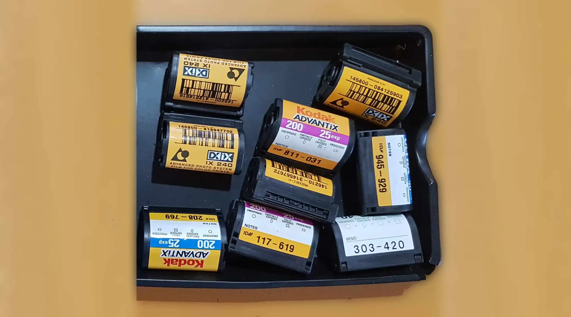 A pile of APS cartridges in a box