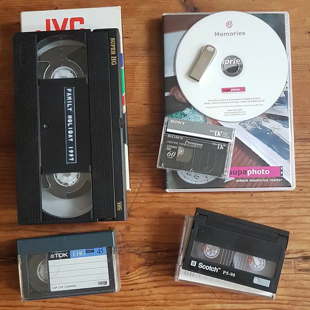 Video tapes on a table inc vhs, video 8, hi 8, digital 8 & mini dv tapes with DVD Case & USB