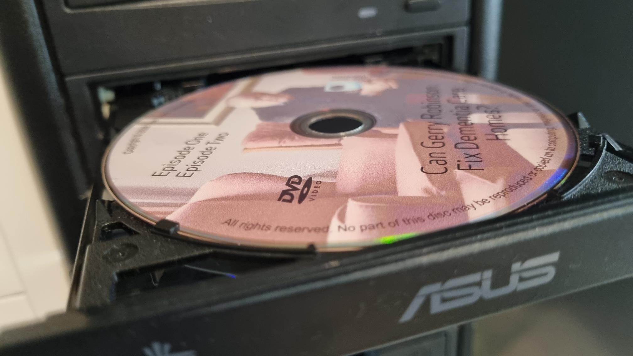 Can Gerry Robinson Fix Dementia Care Homes? disc being played in a DVD player.