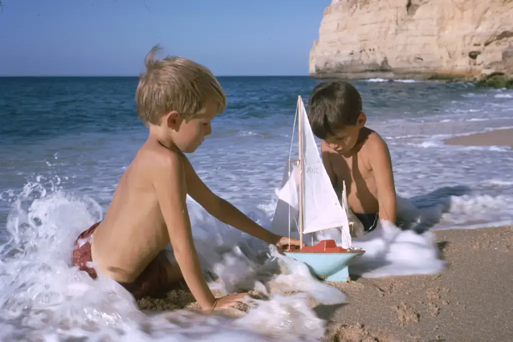 AI enhanced image of two kids plating in the sand. Supaphoto© 2023