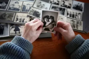 Older person in the process of learning how to preserve old scrapbooks