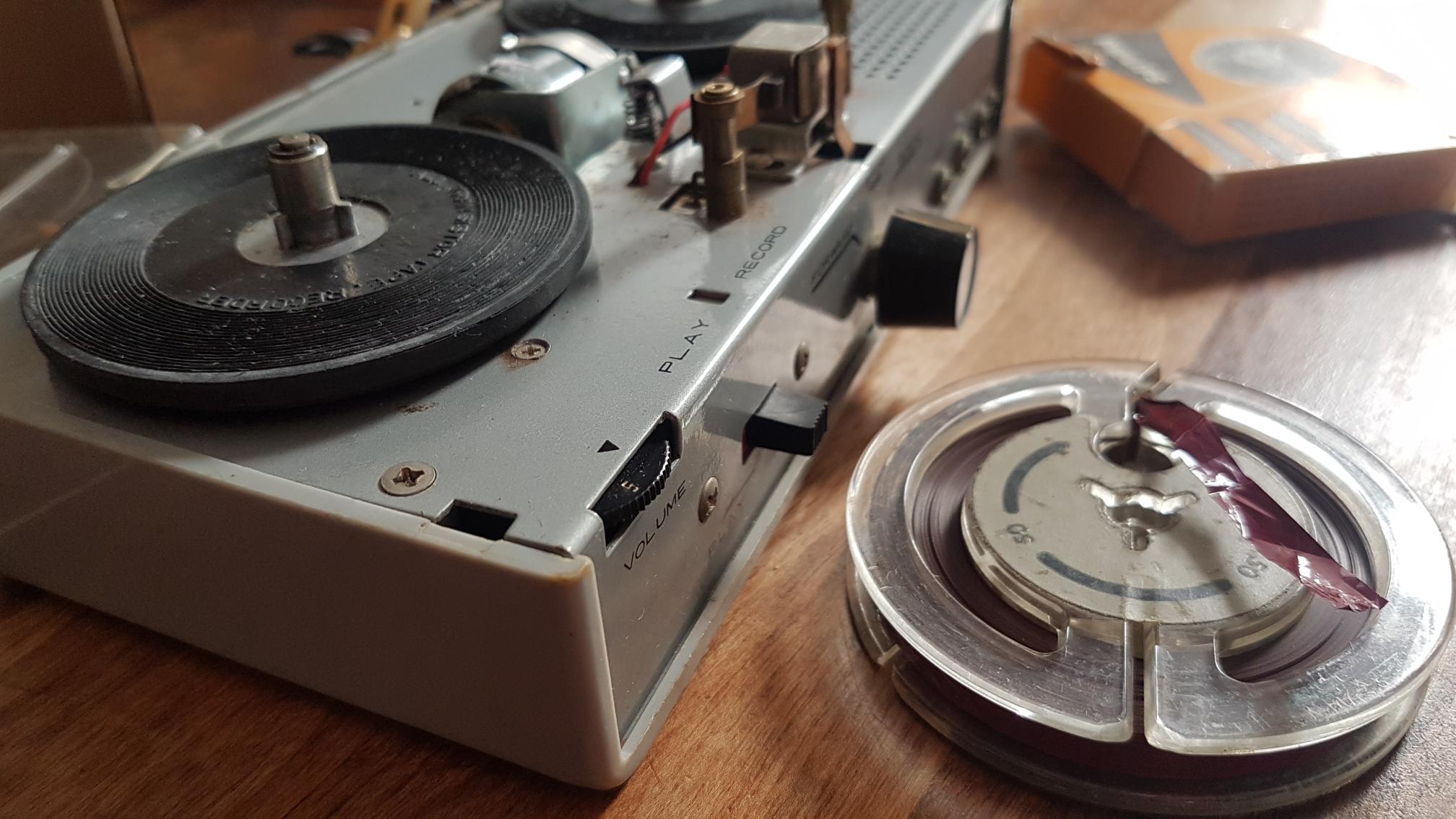 Reel to reel converter machinery on table.