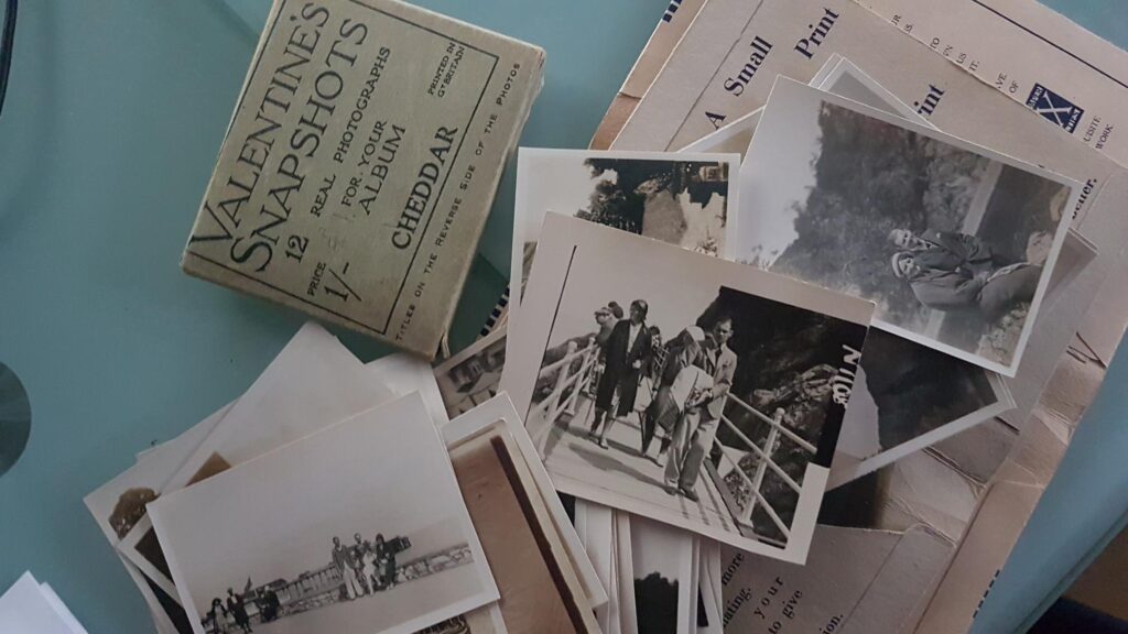 Old Photos Strewn Against Photo Wallets from 1940s